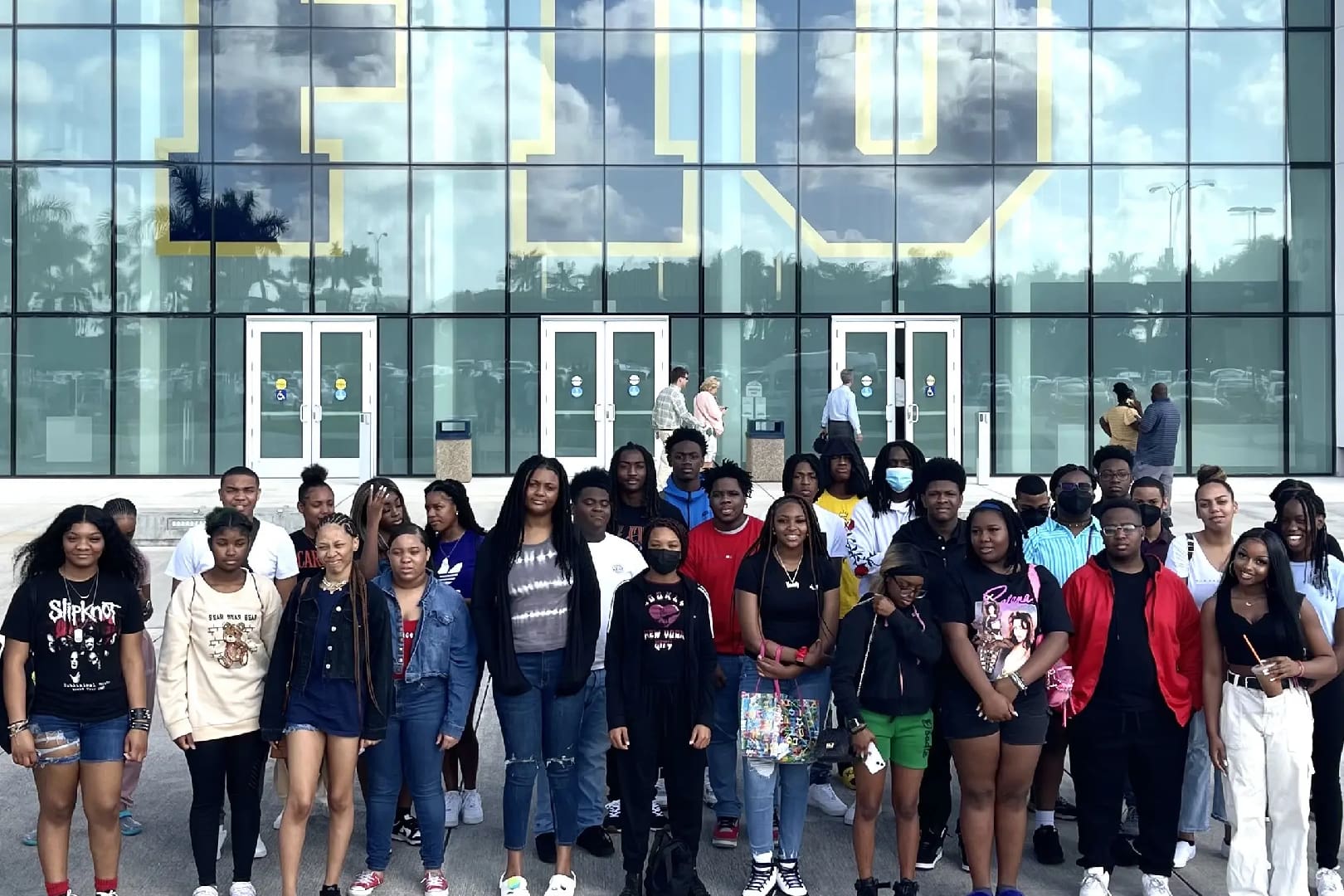 A group of people standing in front of a building.